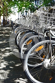 City bikes for rent parked in a row - alternative urban transportation means