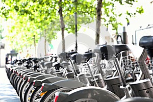 City bikes for rent parked in a row - alternative urban transportation means