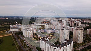 City block. Modern multi-storey buildings. Flying at dusk at sunset. Aerial photography