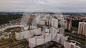 City block. Modern multi-storey buildings. Flying at dusk at sunset. Aerial photography