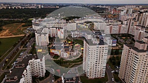 City block. Modern multi-storey buildings. Flying at dusk at sunset. Aerial photography