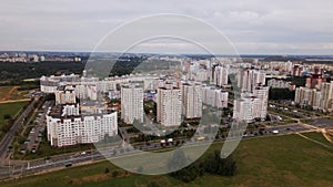 City block. Modern multi-storey buildings. Flying at dusk at sunset. Aerial photography