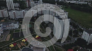 City block. Modern multi-storey buildings. Flying at dusk at sunset. Aerial photography.