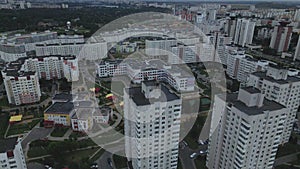 City block. Modern multi-storey buildings. Flying at dusk at sunset. Aerial photography.