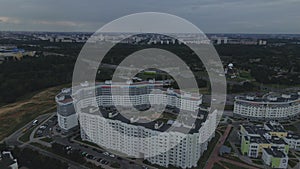 City block. Modern multi-storey buildings. Flying at dusk at sunset. Aerial photography.