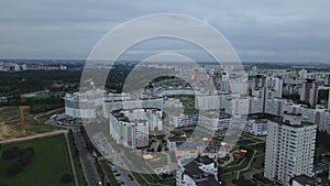 City block. Modern multi-storey buildings. Flying at dusk at sunset. Aerial photography.