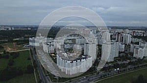 City block. Modern multi-storey buildings. Flying at dusk at sunset. Aerial photography.