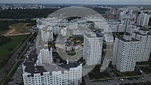 City block. Modern multi-storey buildings. Flying at dusk at sunset. Aerial photography.