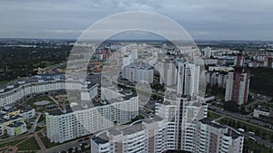 City block. Modern multi-storey buildings. Flying at dusk at sunset. Aerial photography.