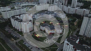 City block. Modern multi-storey buildings. Flying at dusk at sunset. Aerial photography.