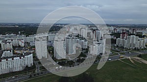 City block. Modern multi-storey buildings. Flying at dusk at sunset. Aerial photography.