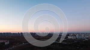 City block. Modern multi-storey buildings. Flying at dusk at sunset. Aerial photography