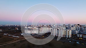 City block. Modern multi-storey buildings. Flying at dusk at sunset. Aerial photography