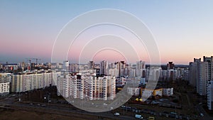 City block. Modern multi-storey buildings. Flying at dusk at sunset. Aerial photography