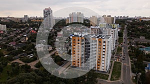 City block. Modern multi-storey buildings in the private sector. Flying at dusk at sunset. Aerial photography