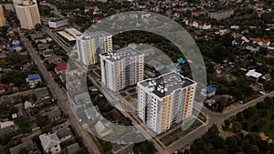 City block. Modern multi-storey buildings in the private sector. Flying at dusk at sunset. Aerial photography