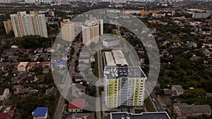 City block. Modern multi-storey buildings in the private sector. Flying at dusk at sunset. Aerial photography