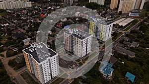 City block. Modern multi-storey buildings in the private sector. Flying at dusk at sunset. Aerial photography