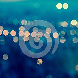 city blurring lights abstract circular bokeh on toned blue background , closeup , retro style