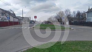 City boulevard with fenced individual residential buildings. The dividing strip between the two carriageways of the road is plante