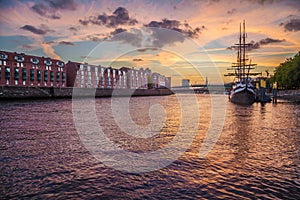 City of Bremen with old sailing ship on Weser river at sunset, Germany