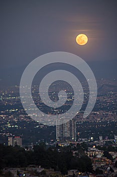 City building with a full moon photo