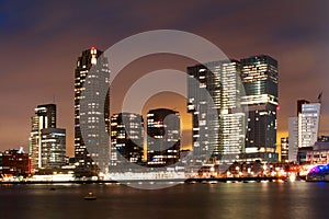 City buildings of Rotterdam at night in front of the sea, the Netherlands