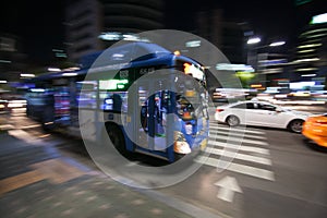 City bus motion blurred in the night