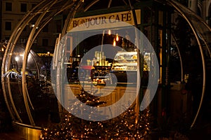 City cafe in a transparent dome, night time. Outdoor cafe in transparent sphere, winter, garland lights