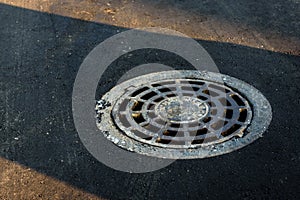 City canal hatch/cover on the asphalt road