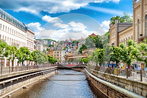 The city center with buildings and hotels along the river Tepla