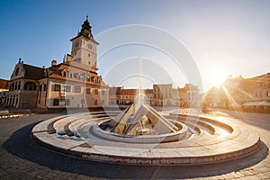 City central square (Piata Sfatului) with town council hall tower, fountain morning sunrise view, location Brasov, Transylvania,