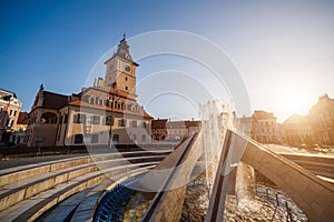 City central square (Piata Sfatului) with town council hall tower, fountain morning sunrise view, location Brasov, Transylvania,