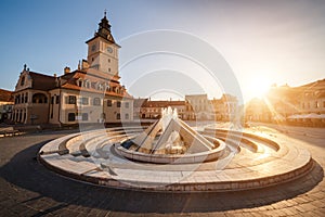 City central square (Piata Sfatului) with town council hall tower, fountain morning sunrise view, location Brasov, Transylvania,