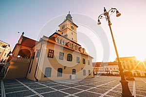 City central square (Piata Sfatului) with town council hall tower morning sunrise view, location Brasov, Transylvania, Romania.