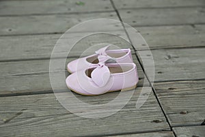 City Cesis, Latvian Republic. Pink baby booties stand on a wooden floor. July 14 2019. Travel photo