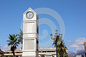 the city clock tower against the blue sky