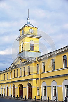 City Clock Tower over yellow house, urban architecture