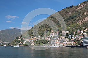 City on coast of lake in mountains. Como, Italy
