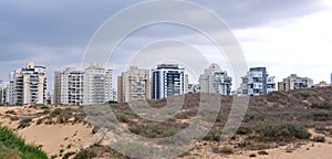 City construction among desert dunes. Building yard of Housing construction of houses in  new area of the city Holon in Israel