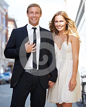 City date, valentines love and couple portrait with a smile ready for romance and happiness on a street. Suit, smile and