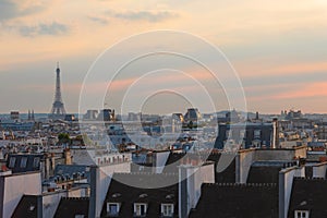 City day view of Parisian rooftops and Eiffel Tower. Famous landmark, icon, tourist destination in Paris, France.