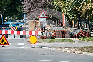 City district heating pipeline reparation and reconstruction parallel with the street with construction machinery and safety road