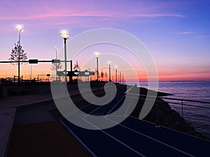 city Evening promenade at port pier city light people walking on horizon sunset pink sea and sky panorama Tallinn Estonia