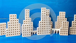 City of figures of buildings on a blue background. Concept for real estate, urban environment and transport infrastructure