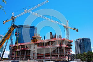City first-stage building construction showing blocks and steel with cranes