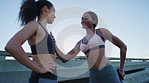 City, fitness or friends stretching before running exercise, cardio workout or body training on a bridge or road. Women