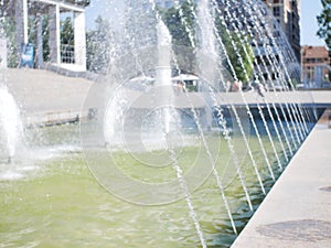 City fountain. Blurred background. Fantana jets, close-up directed upwards