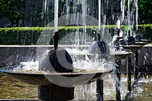 City fountain with cool water in hot summer weather. Long exposure. Contrast and close-up