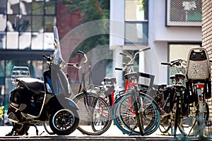 City fragment - parked bicycles against the background of residential buildings. Beautiful morning light. Focus on the foreground